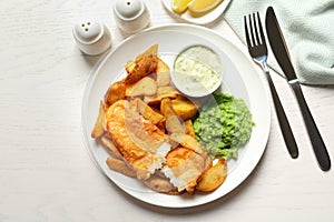 British Traditional Fish and potato chips on wooden background