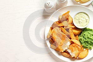 British Traditional Fish and potato chips on wooden background, flat lay