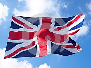 British union flag flying against a blue cloudy sky