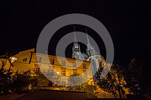 Brno Cathedral of saints peter and paul, seen from the bottow of Petro Hill, at night, surrounded by darkness.