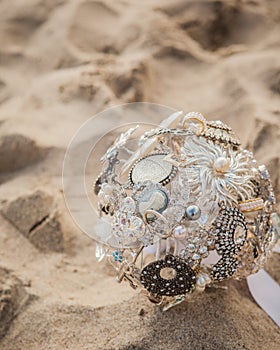 Broach bridal bouquet laying in the sand