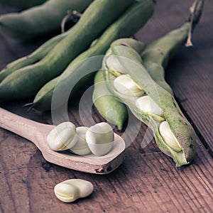 Broad Beans on a wooden Table with Spoon
