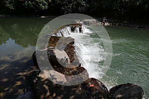 A broad dam spans across the river