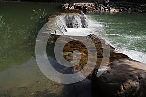 A broad dam spans across the river