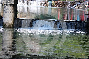 A broad dam spans across the river