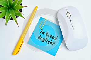 In broad daylight - english time idiom hand lettering on wooden blocks