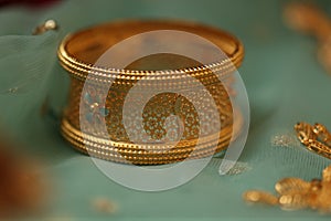 intricately designed gold bangle on display