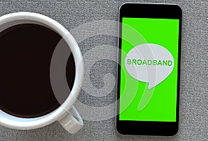 BROADBAND, message on speech bubble with smart phone and and coffee