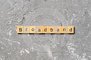 BROADBAND word written on wood block. BROADBAND text on cement table for your desing, concept