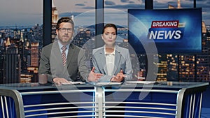 Broadcast presenters reporting news at late night television channel closeup
