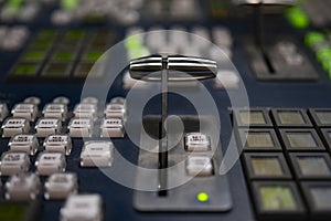 Broadcast television switcher in news studio with blur background.