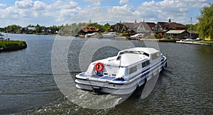 Broads Cruiser on the river Bure at Horning.