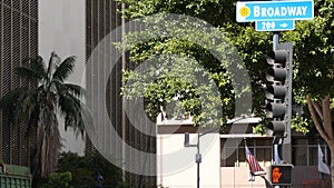 Broadway street name, odonym sign and traffic light on pillar in USA. Road intersection in downtown of city. Crossroad in urban photo