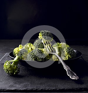 Broccoli on the black stone background