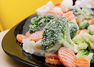 Broccoli, carrots, frozen vegetables on a plate