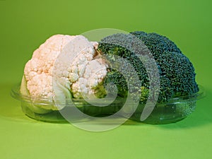 Broccoli and cauliflower. Green background. Healthy lifestyle photo