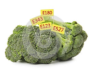 Broccoli with E numbers on background. Harmful food additives