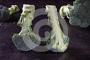Broccoli florets on black background, ideal for vegetarian recipe book or food magazine.