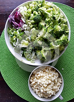 Broccoli, onions, leek chopped in bowls - ingredients for vegetarian meal