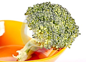 Broccoli in an orange saucer
