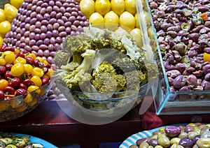 Broccoli, peppers, olives and lemons for sale in the Medina Souk in Meknes, Morocco.