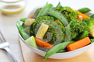 Broccoli salad with carrot ,baby corn and snap pea photo