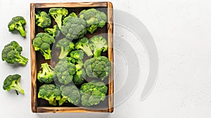 Broccoli in wooden box on white background.