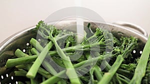 Broccolini with running water from the tap