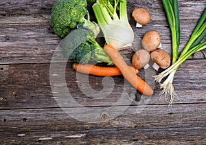 Broccolion, spring onions, fennel, mushrooms and carrots wooden on board