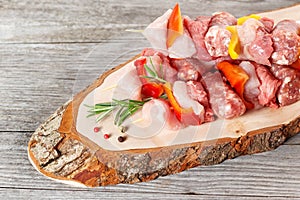 Brochettes on a rustic chopping board