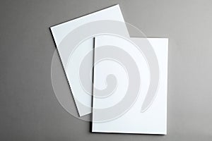 Brochures with blank covers on grey background
