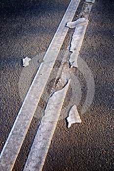 Brocken line of an asphalt road marking close-up