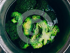 Brocolli boil in the pot. Brocolli changes its color while boiled