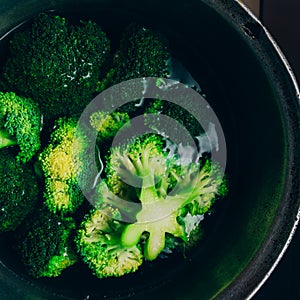 Brocolli boil in the pot. Brocolli changes its color while boiled