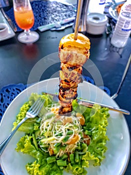 Broiled scallops on a skewer