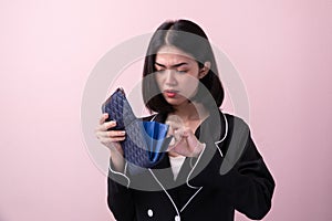 Broke asian women open empty purse isolated on background