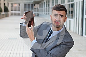 Broke businessman showing his empty wallet