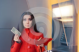 Broke Woman Holding One Dollar in Front of an ATM