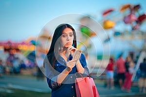 Broke Woman Holding one Dollar at Summer Funfair