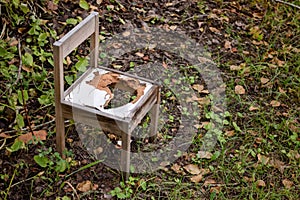 Broken and abandoned chair in the woods