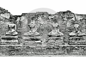 Broken Ancient Buddha Statues Ruins at Wat Chaiwatthanaram in The Historic City of Ayutthaya, Thailand in Classic Vintage Black an