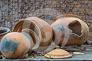 Broken antique clay pot or traditional Jar on abandoned hut