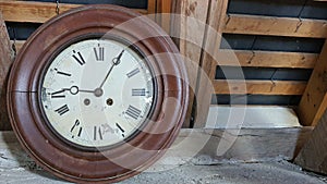 Broken antique clock with wooden frame and Roman numerals