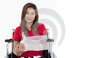 Broken arm Asian woman with arm sling sponsored in her hands sit