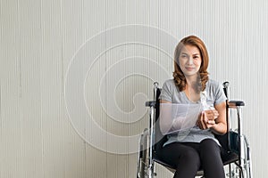 Broken arm Asian woman with arm sling sponsored in her hands sitting on a wheelchair Ideas for accident Injuries