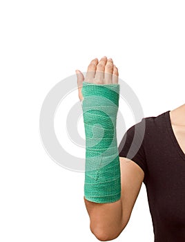 Broken arm with green cast on white background