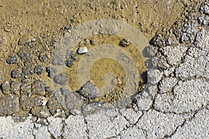 Broken Asphalt With Mud Hole