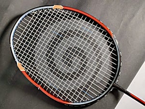 Broken badminton racket on black background