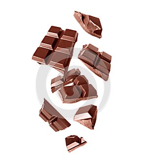 Broken bar of dark chocolate in the air isolated on a white background