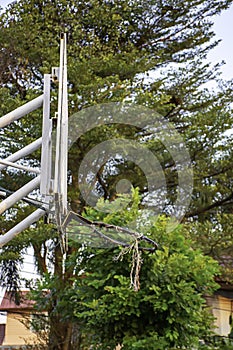 Broken basketball hoop Repair work temporarily background blurry tree and sky